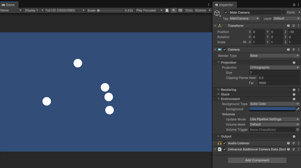 Screen shot of the unity interface showing that the circles appear smaller in the game view as a result of increasing the size of the camera to 7