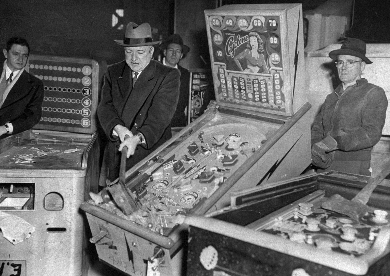 New York City Police Commissioner William P. O’Brien smashes illegal pinball machines in a warehouse in the Greenpoint section of Brooklyn